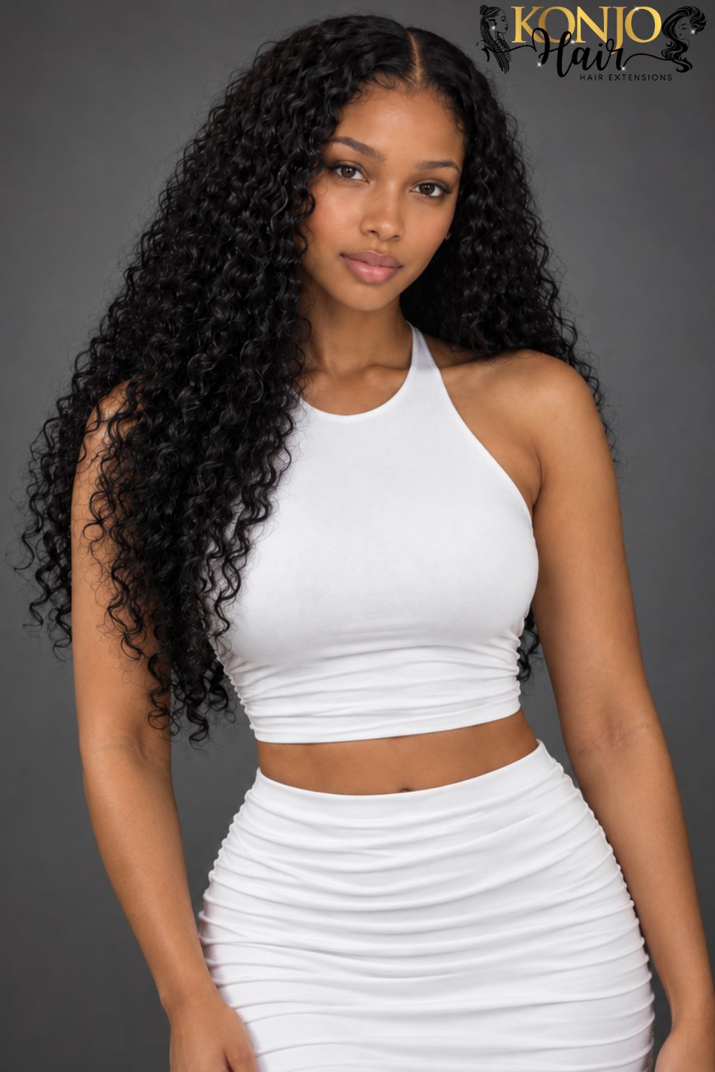 Front view of a woman wearing long black Burmese curly hair extensions with a middle part, defined curls, and natural fullness.